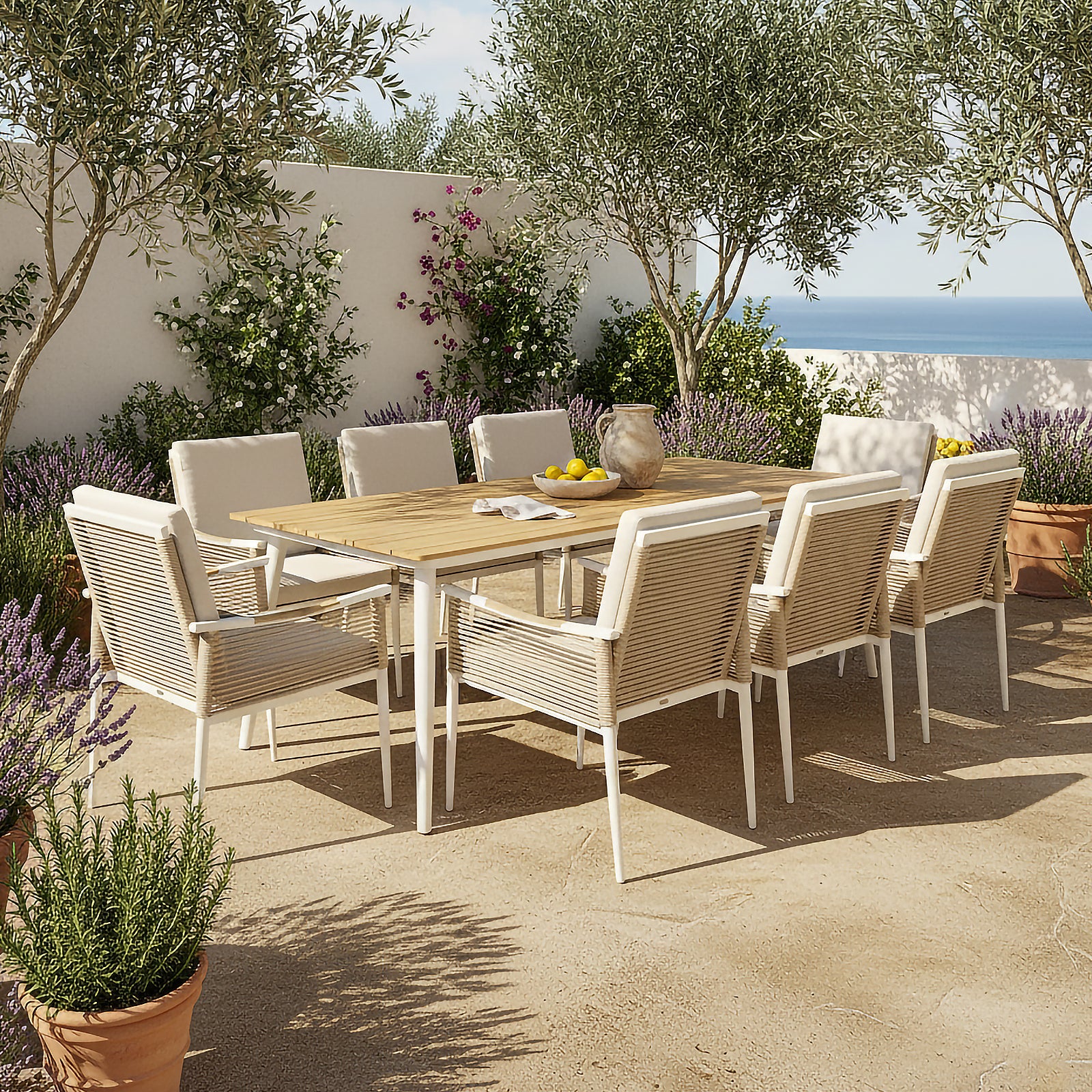 Casara 9 Piece Outdoor Dining Set in White and Beige features a wooden-topped table with slender metal legs, surrounded by eight white-washed wooden chairs with woven backs and cushioned seats, set on a sunlit terrace.