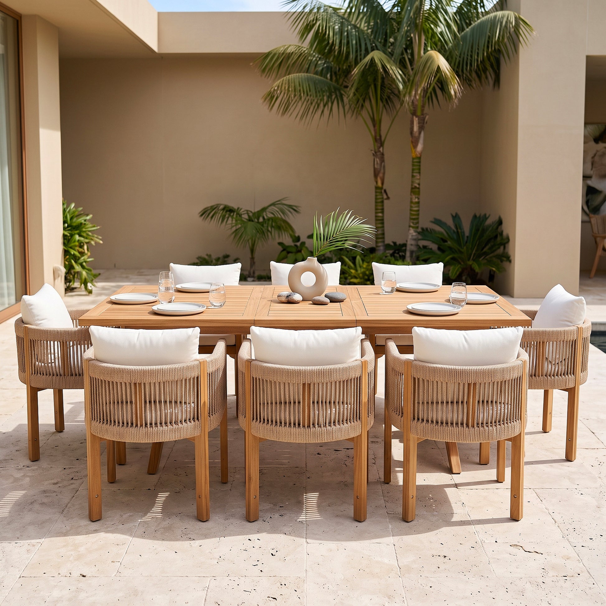 Outdoor dining set staged on a patio with tropical plants