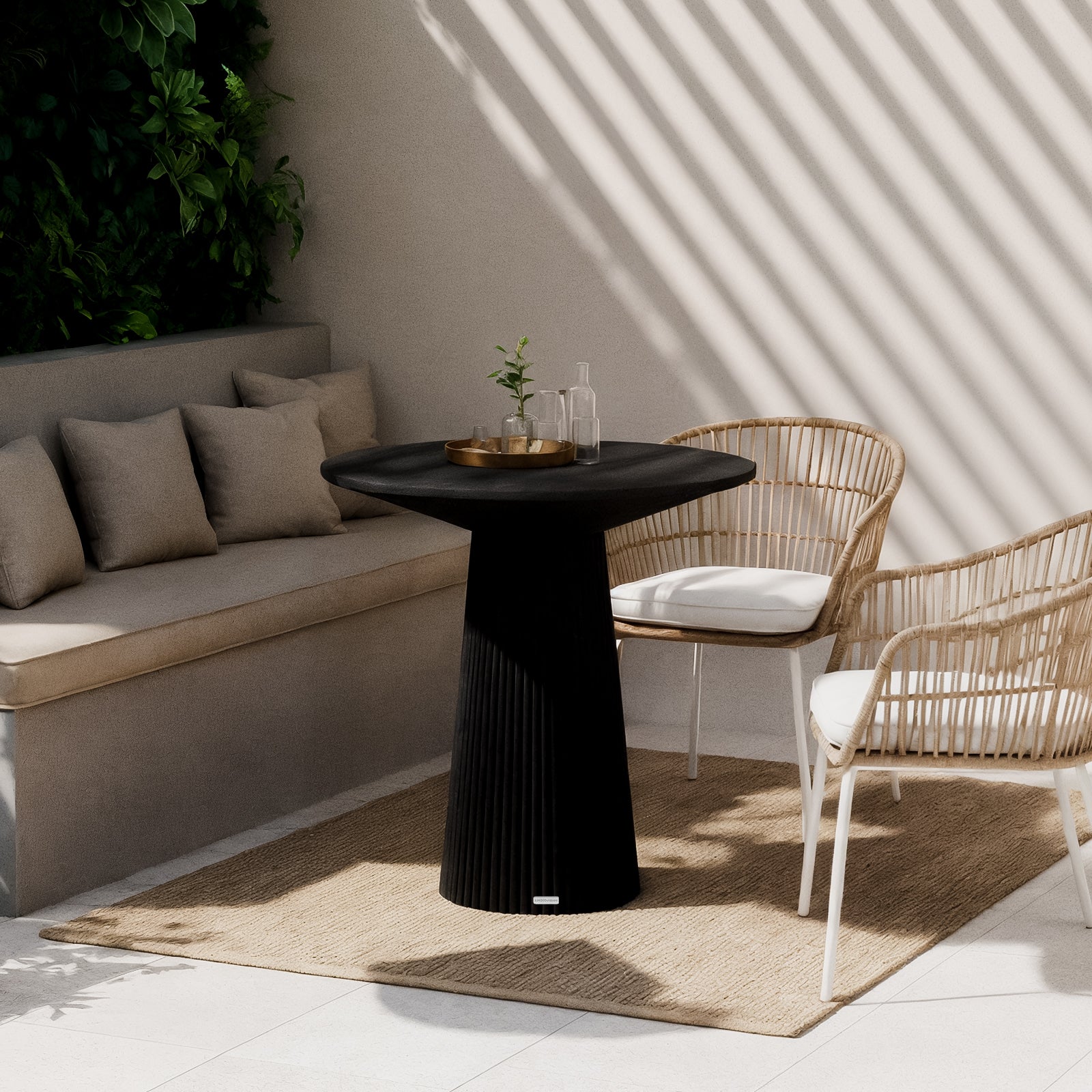 Darien 80cm Round Concrete Bistro Table in Grey Marble features a sleek, marble-look top and fluted base, set in a sunny patio nook with wicker chairs and decorative tray.
