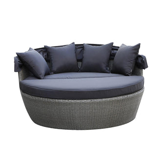 Erith Wicker Outdoor Furniture Day Bed w/ Canopy Brown/Black shown with soft cushions, positioned on a chair and couch, highlighting its plush comfort and elegant design for outdoor relaxation.