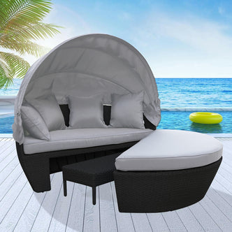 Erith Wicker Outdoor Furniture Day Bed w/ Canopy featuring a plush white pillow, captured on a bed, emphasizing the elegant design and comfort of this luxurious outdoor relaxation piece.