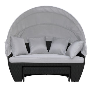 Erith Wicker Outdoor Furniture Day Bed w/ Canopy showcases a plush white pillow on its surface, highlighting comfort and luxury. The day bed is designed for outdoor relaxation and entertaining.