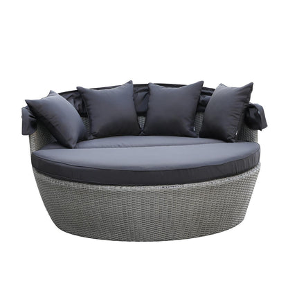 Erith Wicker Outdoor Furniture Day Bed w/ Canopy Grey/Charcoal, featuring a black pillow on a chair, showcasing its luxurious design and comfortable seating perfect for outdoor relaxation and entertainment.