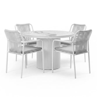 Evone 4 Seater Stone Outdoor Dining Table Set in Light Grey; round table with marble-patterned top, fluted pedestal base, surrounded by four chairs featuring woven backs and gray cushions.