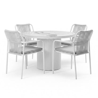 Evone 4 Seater Stone Outdoor Dining Table Set in Light Grey; round table with marble-patterned top, fluted pedestal base, surrounded by four chairs featuring woven backs and gray cushions.