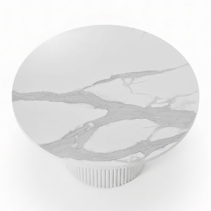 Evone 4 Seater Stone Outdoor Dining Table Set features a round, white marble-patterned tabletop with light gray veining on a fluted pedestal base, perfect for stylish outdoor dining.