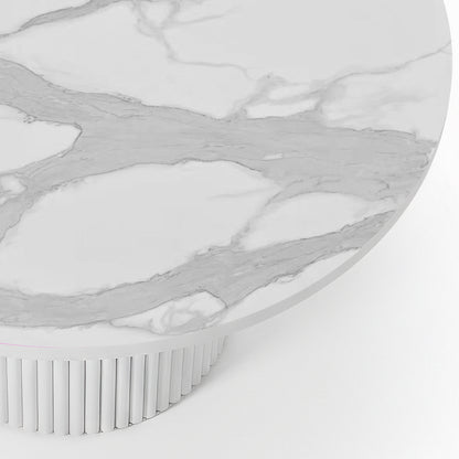 Close-up of the Evone 4 Seater Stone Outdoor Dining Table Set in Natural, featuring a round white marble-effect tabletop with gray veining, atop a cylindrical, fluted white pedestal base.