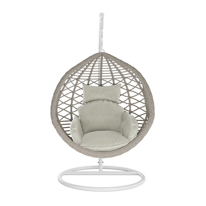 Hilda Large Outdoor Hanging Egg Chair & Cushion in Sage features a woven wicker-style shell on a metal stand, with plush light-beige cushions for comfort, ideal for versatile indoor and outdoor seating.