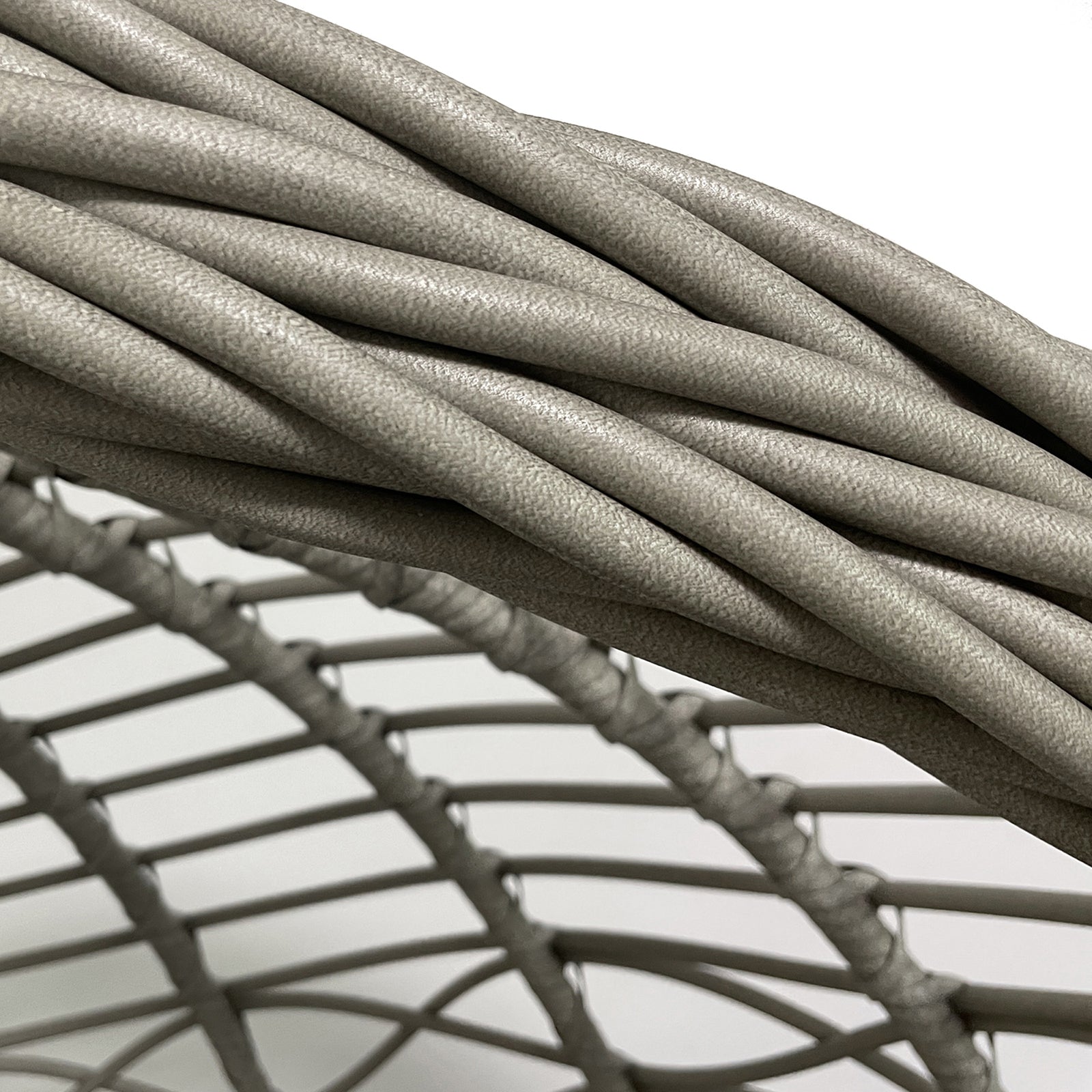 Hilda Large Outdoor Hanging Egg Chair in Sage, showcasing synthetic wicker strands woven around a sturdy metal frame, highlighting its robust construction typical of hanging egg-style seating furniture.