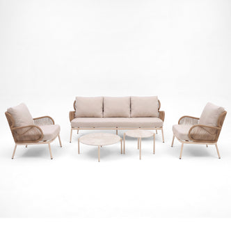 Modern seating set with sofa, two armchairs, and two round coffee tables on a white background
