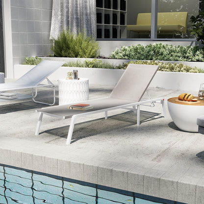 Jabari Textilene Aluminium Outdoor Sunbed in Light Grey, featuring a minimalist design with a durable metal frame and adjustable reclining positions, set beside a pool on light-colored tiles.