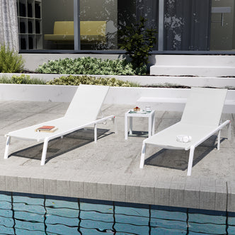 Jabari Textilene Aluminium Sunbed Set of 2 in Cream White, featuring modern white chaise-lounges beside a pool, one with books, the other with headphones, highlighting outdoor relaxation and durability.