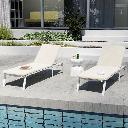 Jabari Outdoor Sun Loungers with Cushions Set of 2 in Cream White on a poolside deck, featuring adjustable reclining positions, a small side table with a drink and snacks, and garden planters.