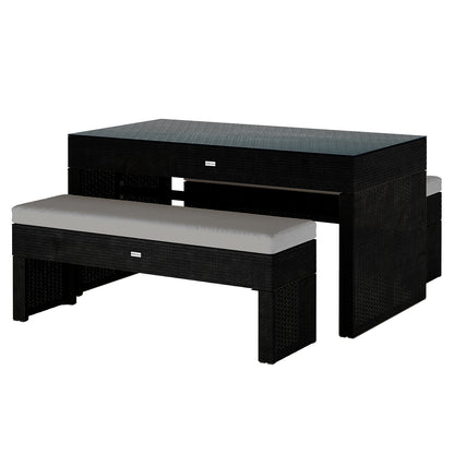 Kummi 4 Seater Outdoor Dining Bench Set features a black rattan-style table with a dark top and two benches with grey cushions, designed for seamless storage and outdoor elegance.