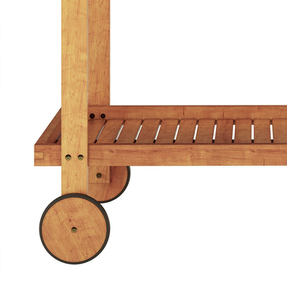 Maiden Solid Wood Outdoor Kitchen Trolley Cart in Natural featuring two wooden wheels, brass fasteners on a vertical post, and a slatted shelf, highlighting its rustic charm and durability.