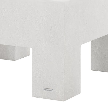 Detail shot of the Maxon White concrete coffee table's surface and leg, featuring the Luxo Outdoors tag