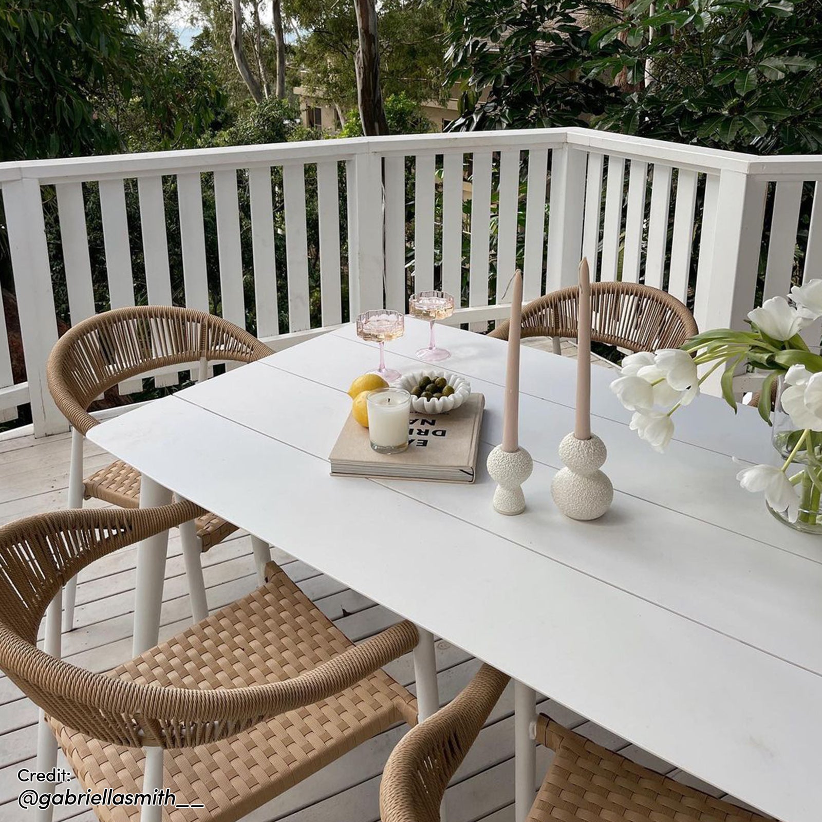 Nemma 6-Seater Aluminium Outdoor Dining Set with a sleek design; features a table adorned with wine glasses and a plate of olives, complemented by a stylish arrangement on a patio table.