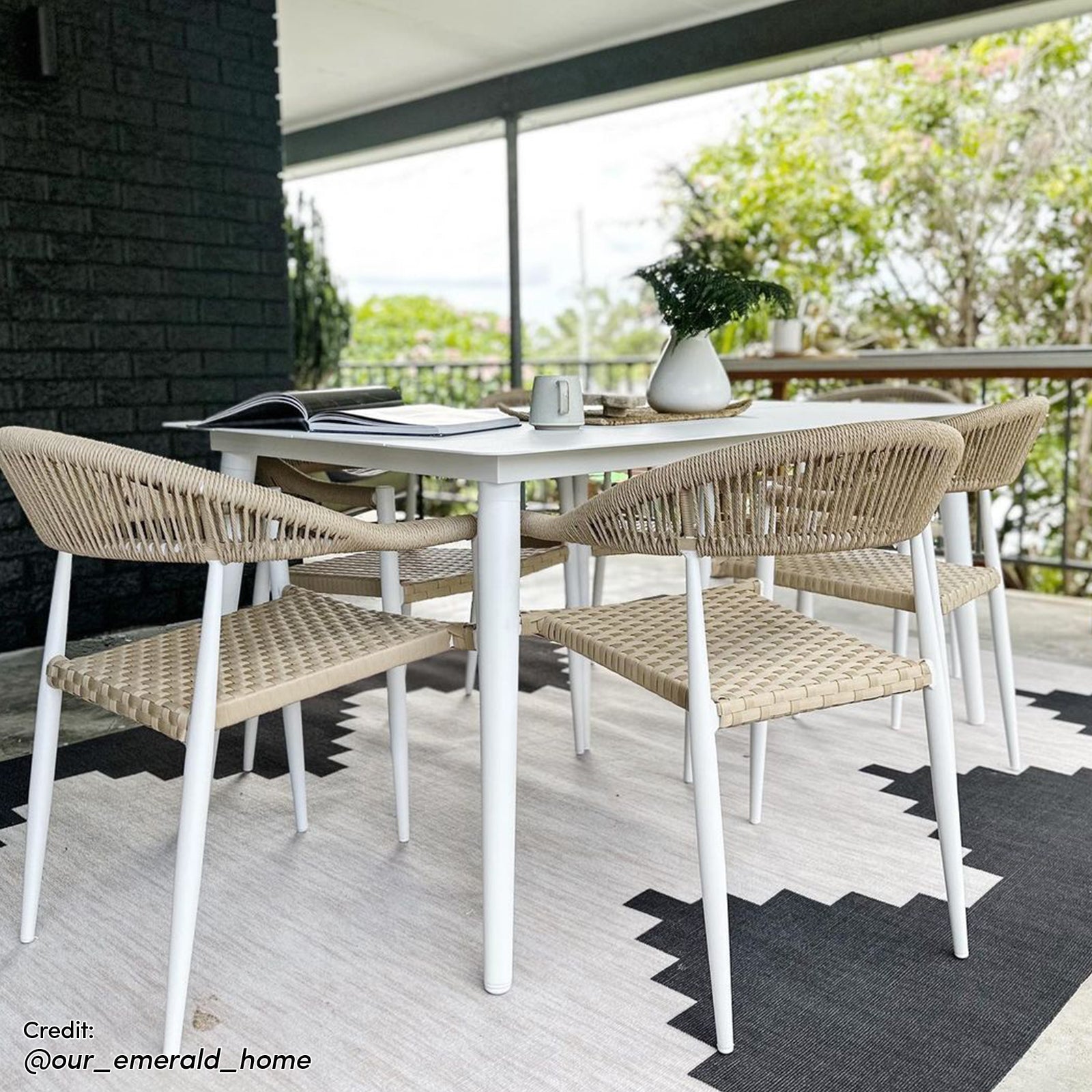 Close-up view of the Nemma 6-Seater Aluminium Outdoor Dining Set showcasing sleek aluminium chairs, a stylish table, and a decorative white vase with green leaves, perfect for enhancing outdoor gatherings.