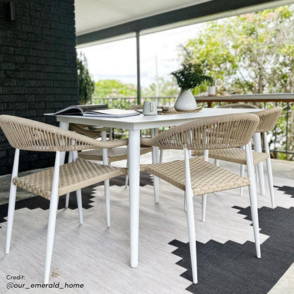 Close-up view of the Nemma 6-Seater Aluminium Outdoor Dining Set showcasing sleek aluminium chairs, a stylish table, and a decorative white vase with green leaves, perfect for enhancing outdoor gatherings.