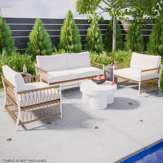 The Nuevo 4 Seater Wicker Outdoor Lounge Set in Light Beige features a two-seat sofa and two armchairs with white cushions, exuding modern elegance beside a pool. (Table not included.)