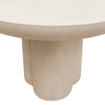 Oberon 120cm Round Outdoor Concrete Dining Table Ivory features a thick top and a pedestal base with a quatrefoil profile, resembling cast stone. A LUXO Outdoors plaque adorns the base.