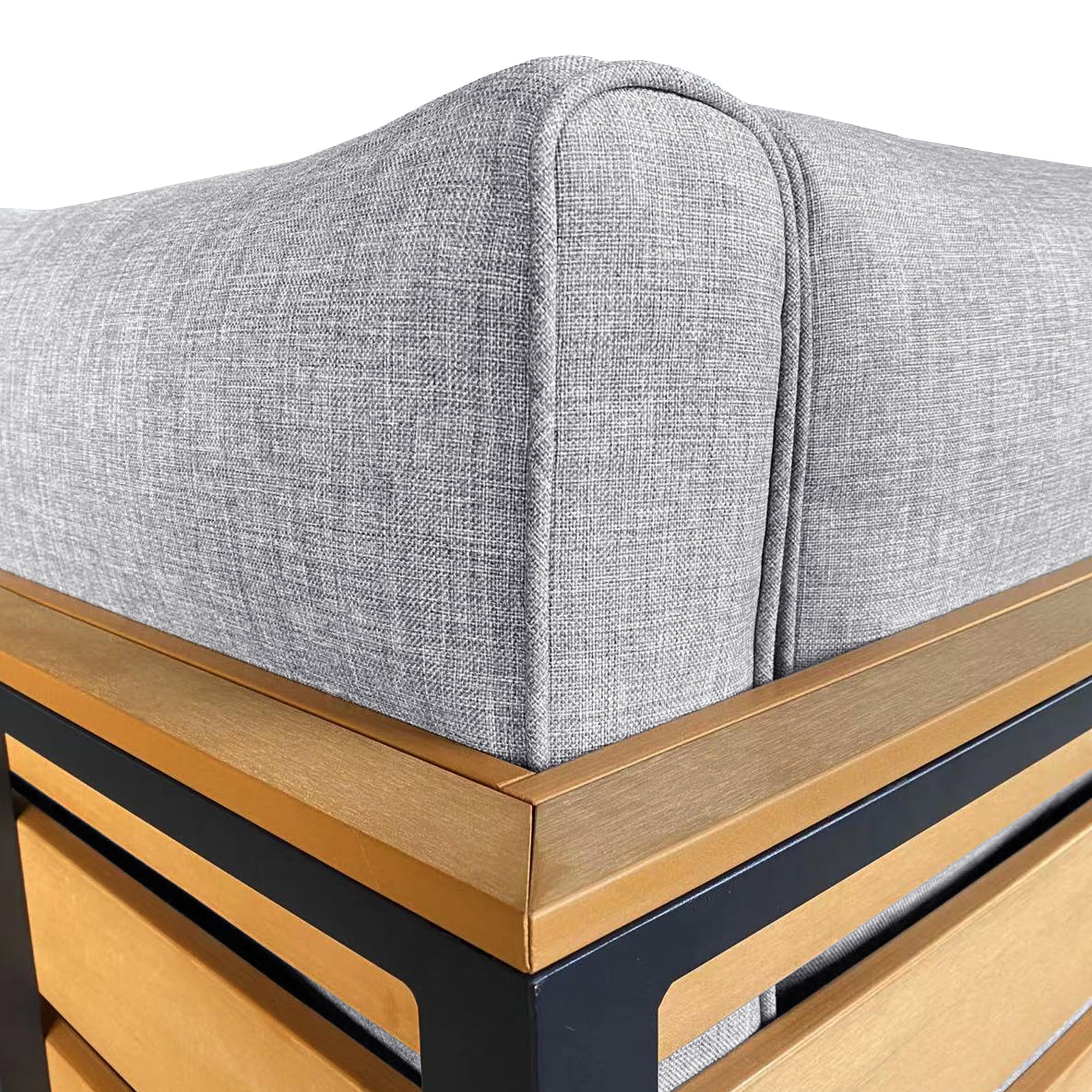 Close-up of the Panaluu 5-Seater Aluminium Corner Outdoor Lounge in Grey, highlighting the textured fabric cushion set within a sleek light brown wooden frame with contrasting black metal supports.
