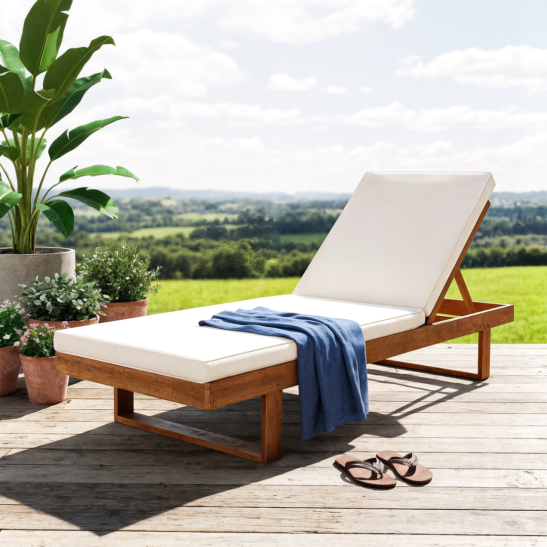 Panay Solid Timber Outdoor Sun Lounger with Cushion in Cream Timber, featuring a wooden frame, off-white cushions, blue throw, adjustable backrest, and potted plants, set on a sunlit deck.
