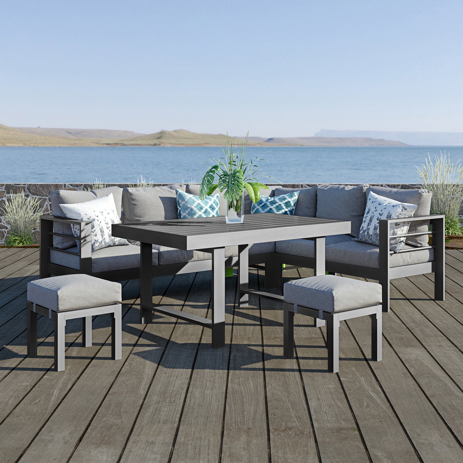 Portland Outdoor Corner Sofa Lounge with Footstools Grey, featuring plush cushions on a robust aluminum frame, paired with a sleek coffee table, set in a serene outdoor setting.