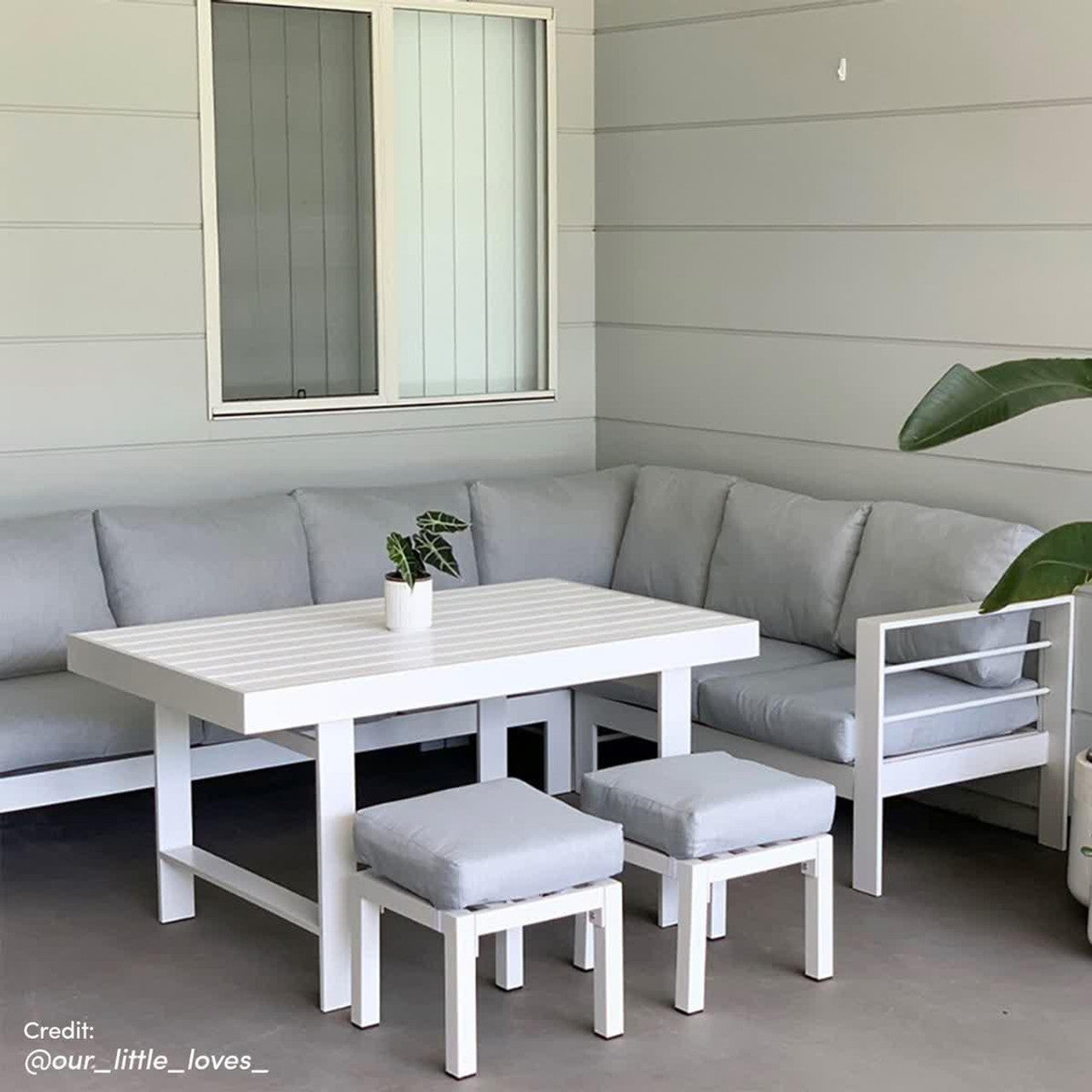 Portland Outdoor Corner Sofa Lounge with Footstools, featuring plush cushions on a sleek, durable frame, ideal for outdoor relaxation. Pictured with a plant and chair, enhancing modern patio design.