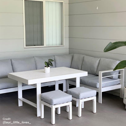 Portland Outdoor Corner Sofa Lounge with Footstools, featuring plush cushions on a sleek, durable frame, ideal for outdoor relaxation. Pictured with a plant and chair, enhancing modern patio design.