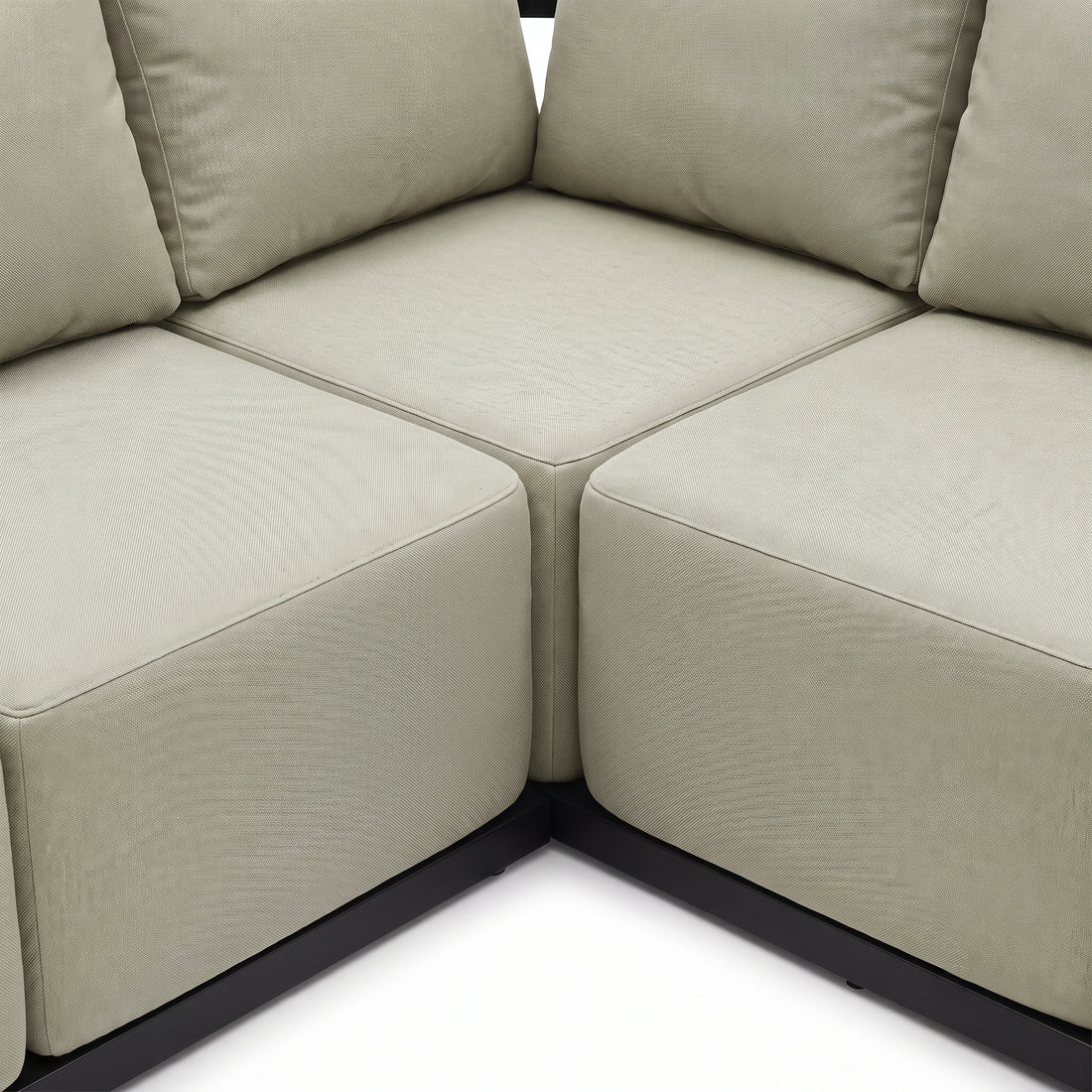 Close-up of a corner section of a beige sectional sofa on a white background
