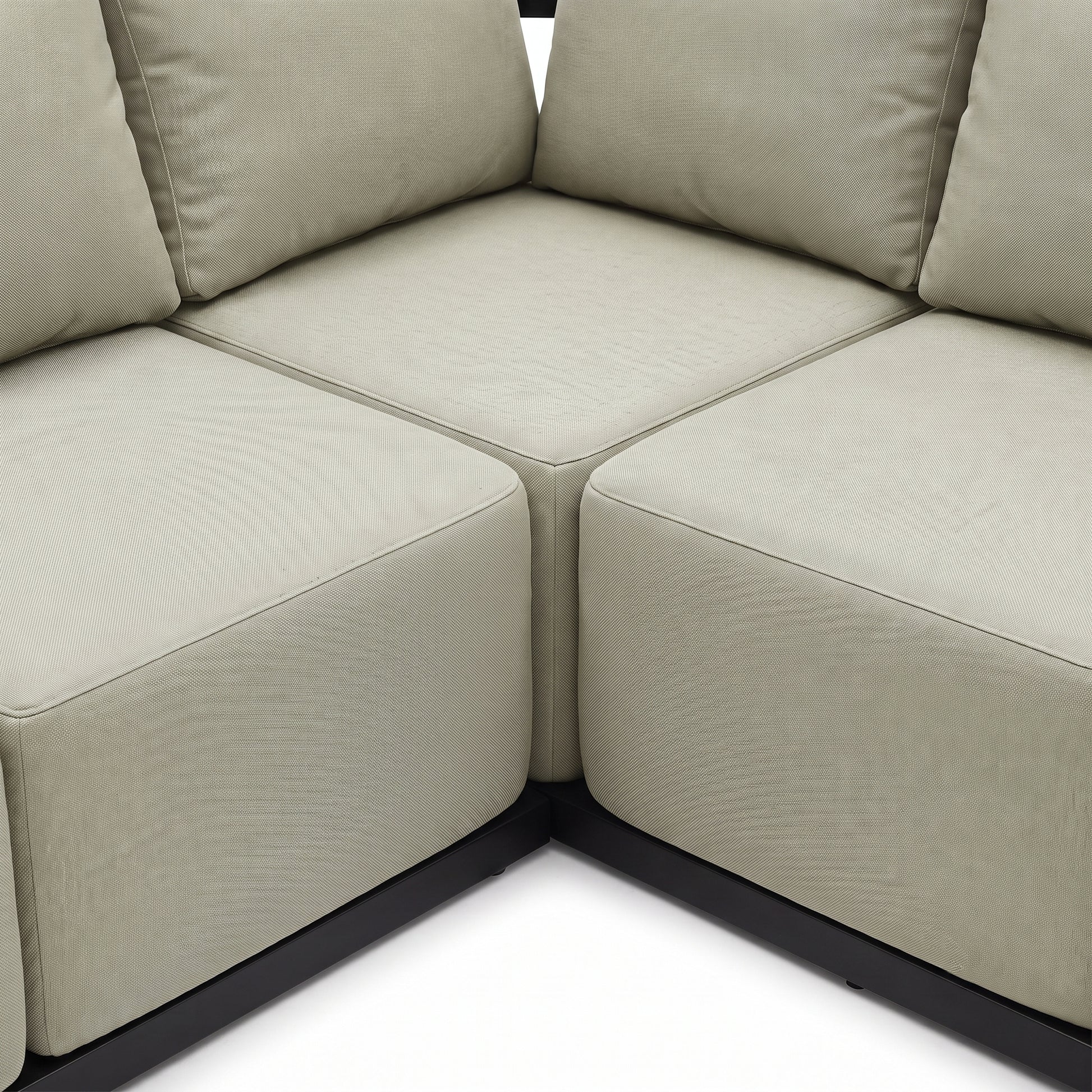 Close-up of a corner section of a beige sectional sofa on a white background