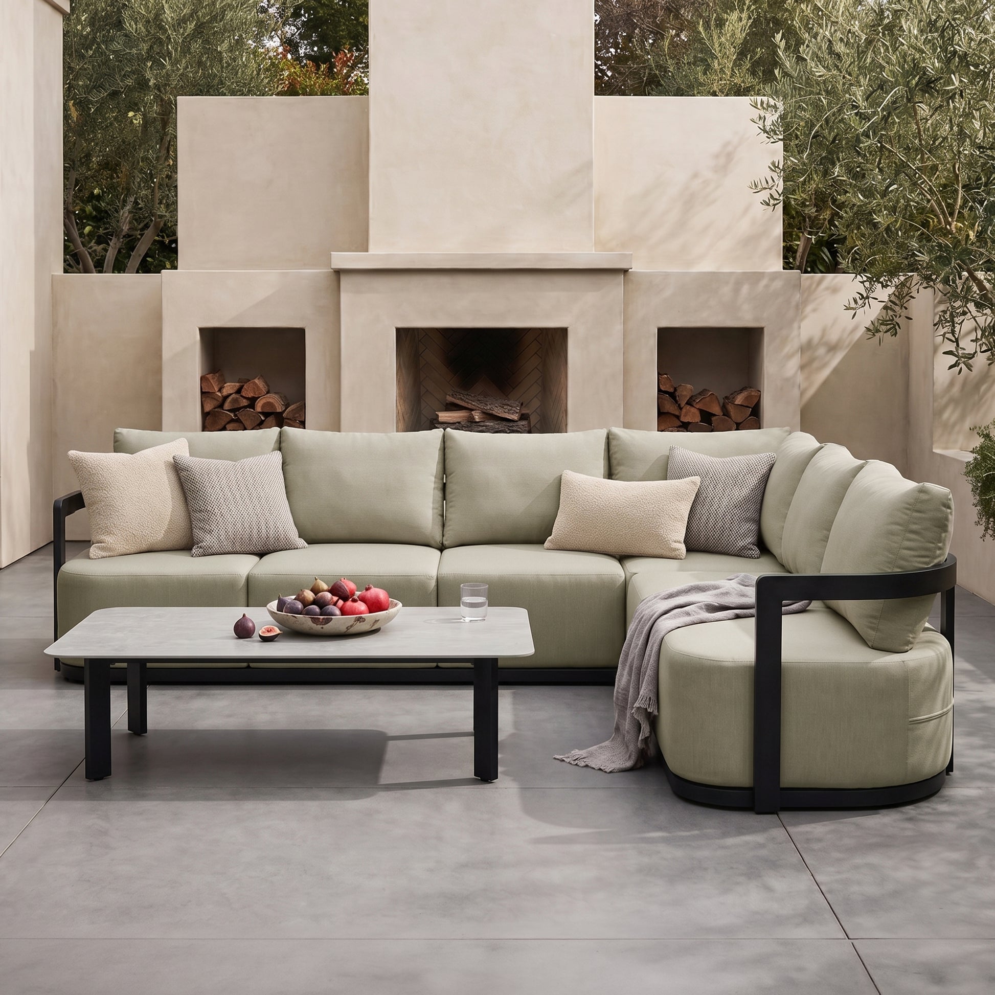 Sectional sofa and coffee table styled in an outdoor patio setting