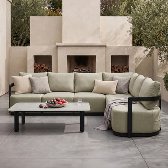 Sectional sofa and coffee table styled in an outdoor patio setting
