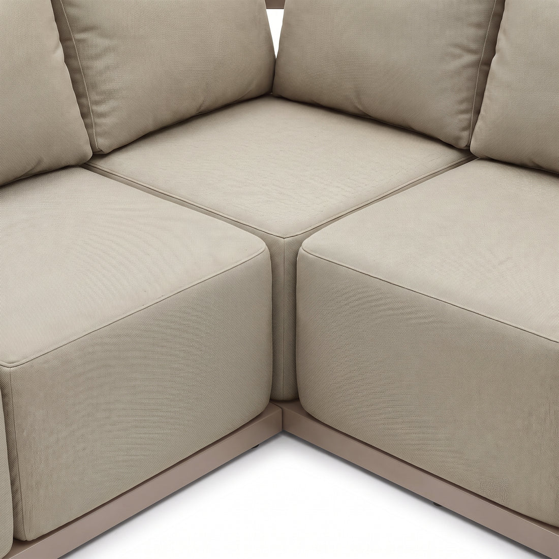 Close-up of beige modular sofa corner with cushions on white background