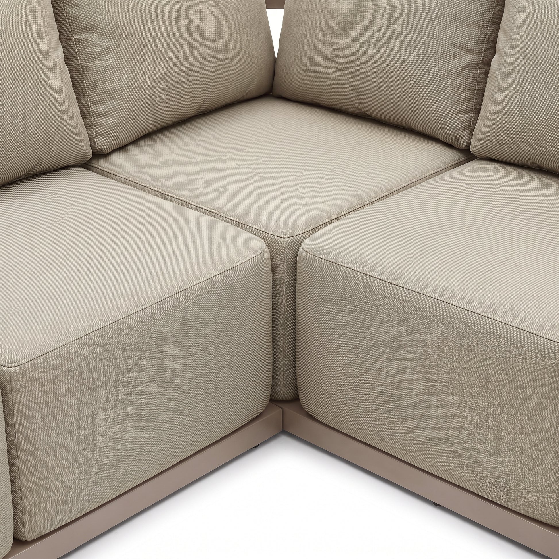 Close-up of beige modular sofa corner with cushions on white background