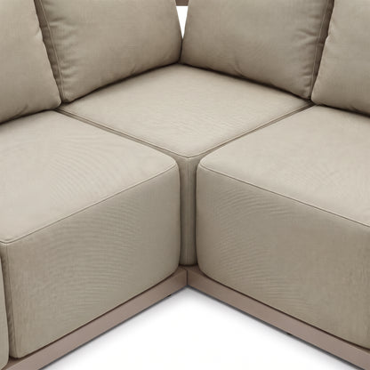 Close-up of beige modular sofa corner with cushions on white background