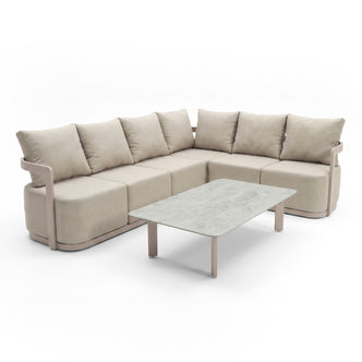 Beige sectional sofa with coffee table shown full on a white studio background