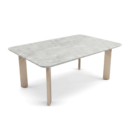 Modern rectangular table with light stone-look top and wooden legs on a white background