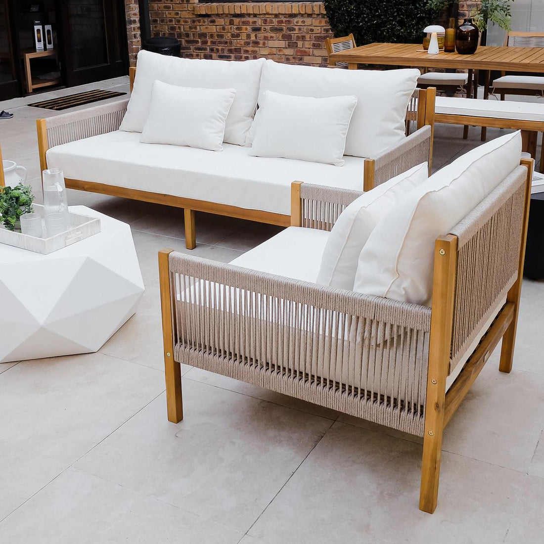 Savin 4-Seater Hardwood Outdoor Sofa Set in Beige, featuring a wooden sofa and armchair with off-white cushions, paired with a geometric coffee table. Perfect for enhancing any outdoor living space.