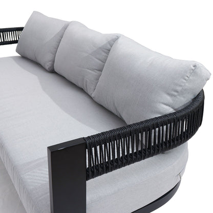 Sorrelle 5 Seater Wicker Outdoor Sofa Set in Black, featuring a round base with a black metal frame, woven-rope sides, light-gray seat cushions, and three matching back pillows.