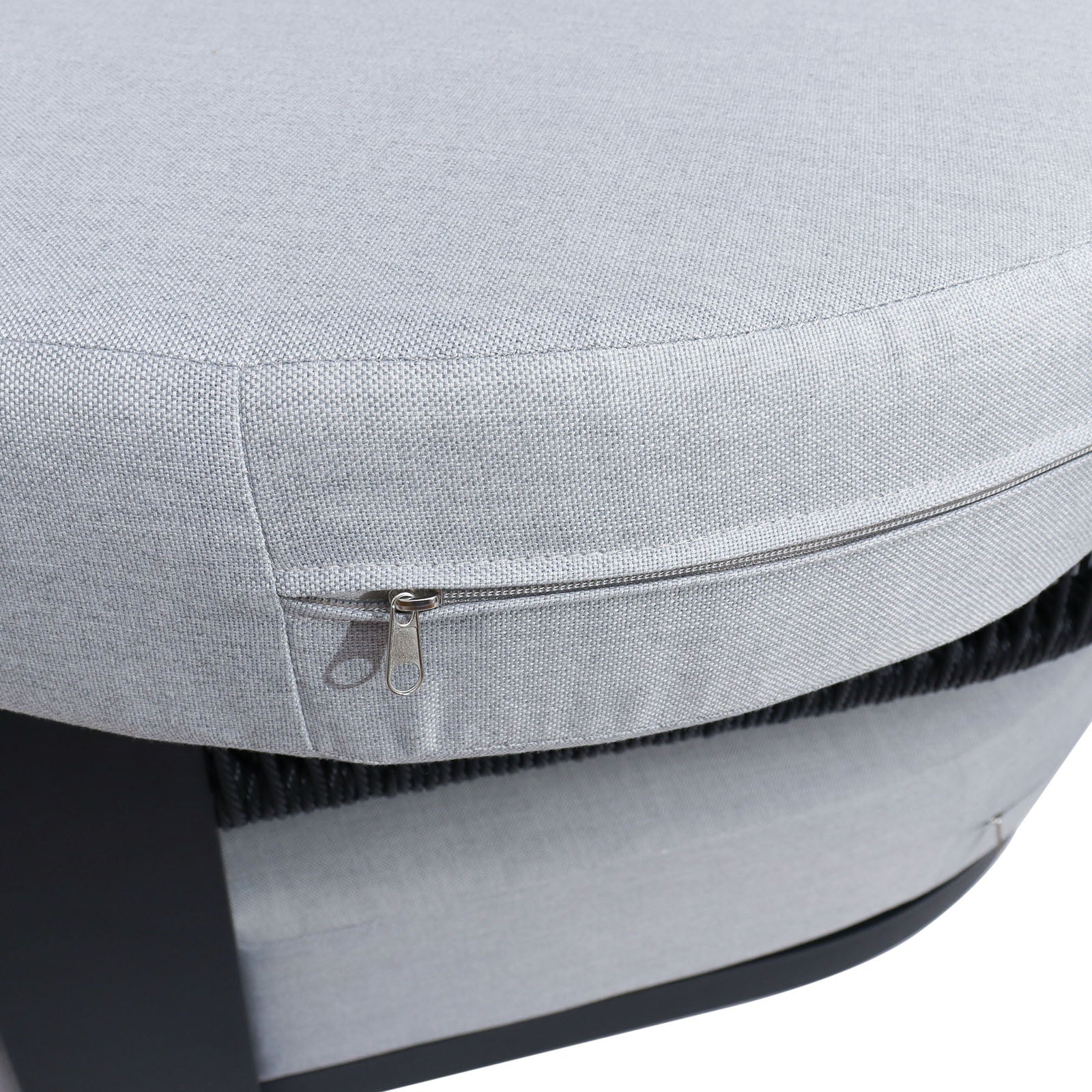 Close-up of Sorrelle 5 Seater Wicker Outdoor Sofa Set in Black, highlighting the light-grey cushion with a metal zipper on its removable cover, suggesting a durable and stylish outdoor furniture option.