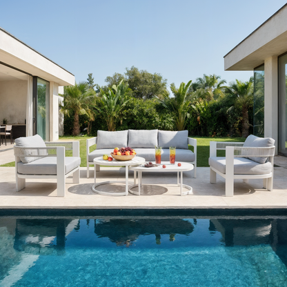 Sorrelle 5-Seater Curved Outdoor Sofa Set in Light Grey by a pool, featuring a three-seat sofa and two armchairs with cushions, accompanied by round coffee tables holding fruit and drinks.