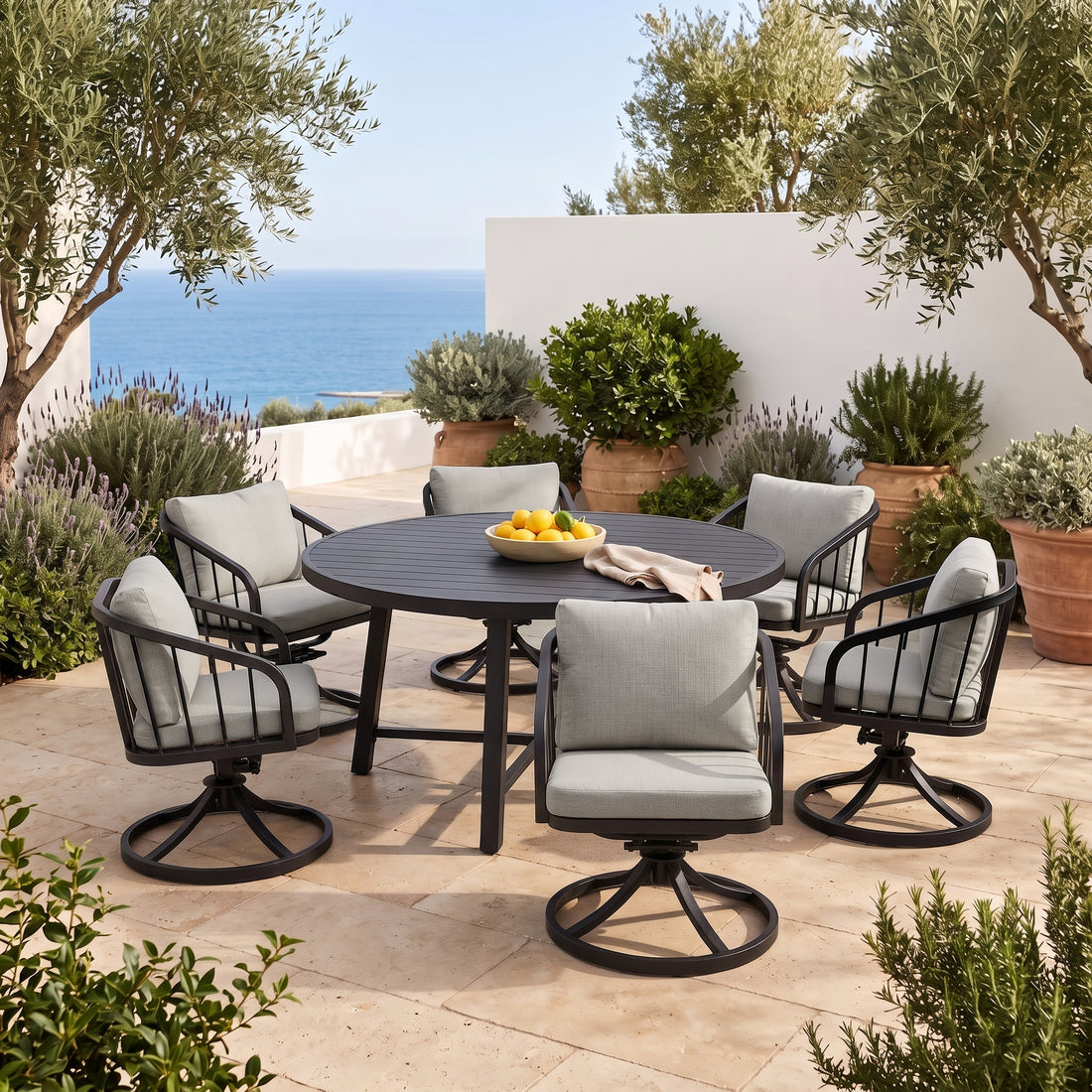 Outdoor dining set with round table and six chairs on a tiled patio with greenery and ocean view
