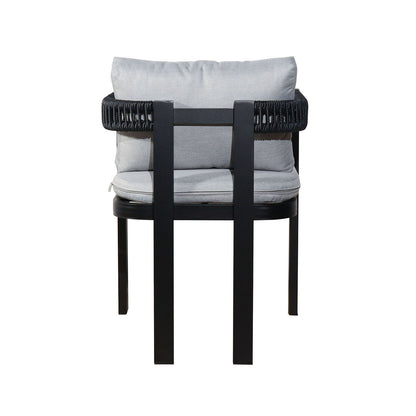 Back view of the Tavari 6-Seater Aluminium Outdoor Dining Set in Black, featuring a black metal frame with woven details and light-gray seat and back cushions, showcasing modern patio chair design.