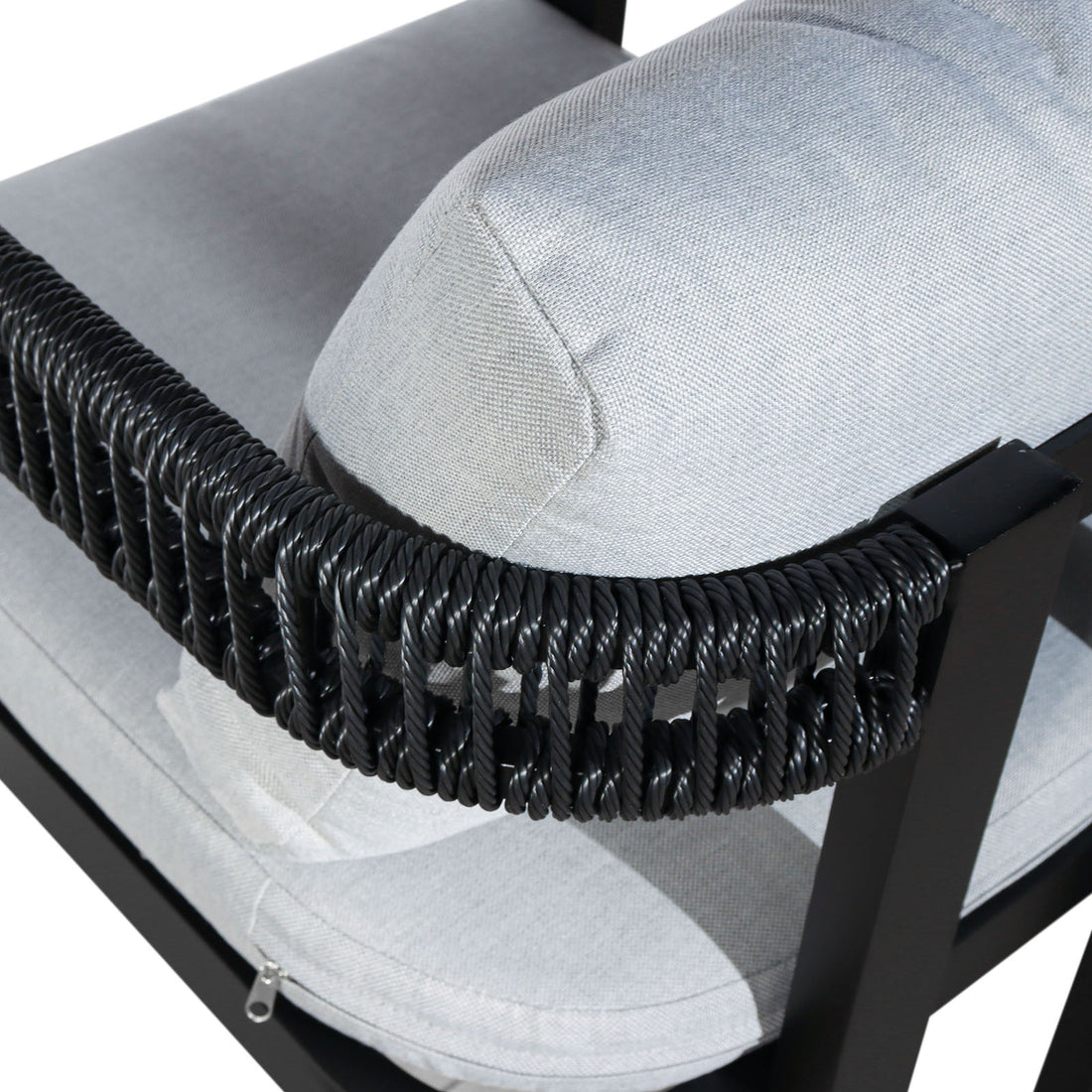 Close-up of the Tavari 6-Seater Aluminium Outdoor Dining Set in Black, highlighting the light-gray upholstered cushion with a visible zipper set into a black metal frame, accented by twisted black synthetic rope.