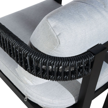 Close-up of the Tavari 6-Seater Aluminium Outdoor Dining Set in Black, highlighting the light-gray upholstered cushion with a visible zipper set into a black metal frame, accented by twisted black synthetic rope.