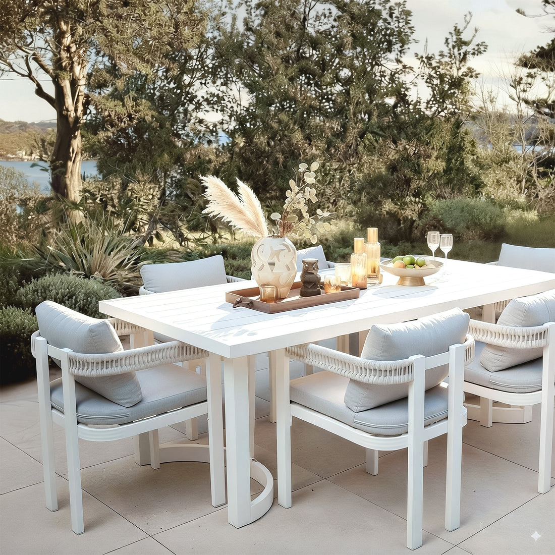 Tavari 208cm 6-Seater Curved Outdoor Dining Set in Light Grey, featuring a white table with matching armchairs, woven rope backs, and light grey cushions, set for stylish outdoor entertaining.