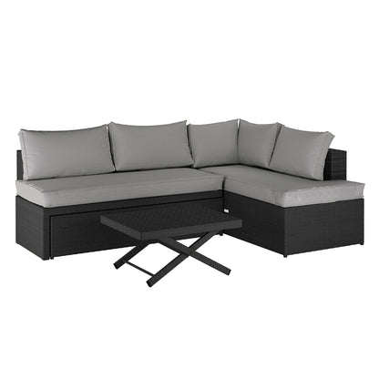 Tybee 4 Seater Rattan Outdoor Corner Sofa Set in Warm Grey featuring a dark woven-rattan style with light gray cushions, arranged as a sectional with a matching low coffee table with X legs.