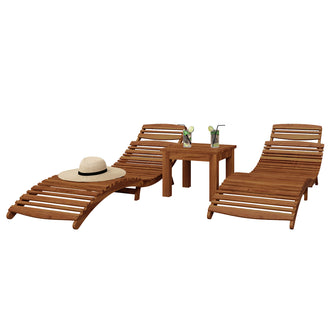 Wave Hardwood Acacia Outdoor Sun Loungers Set of 2 in Natural featuring slatted, gently curved chaise longues and a matching side table, complemented by a straw sun hat and iced drinks with lime slices.